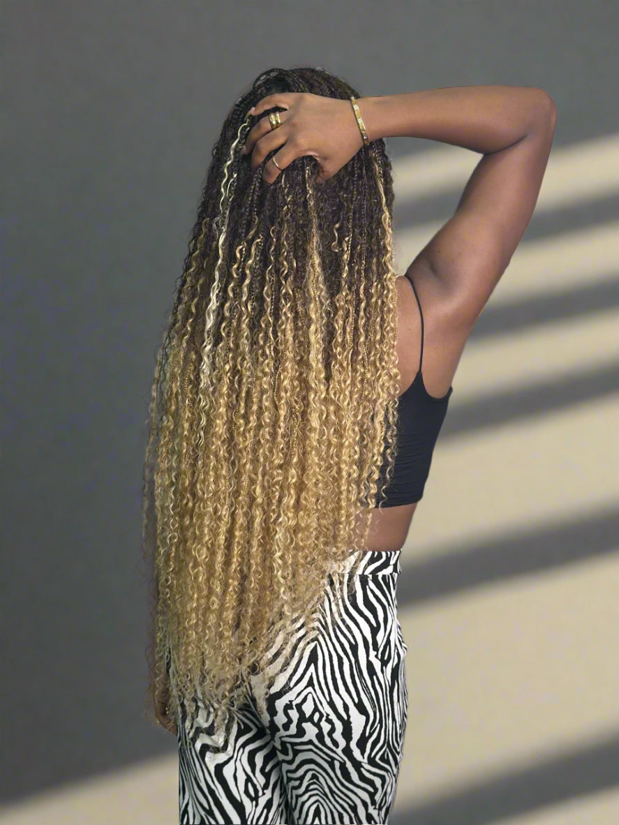 Person with long, styled hair against a neutral background, crochet boho braids style