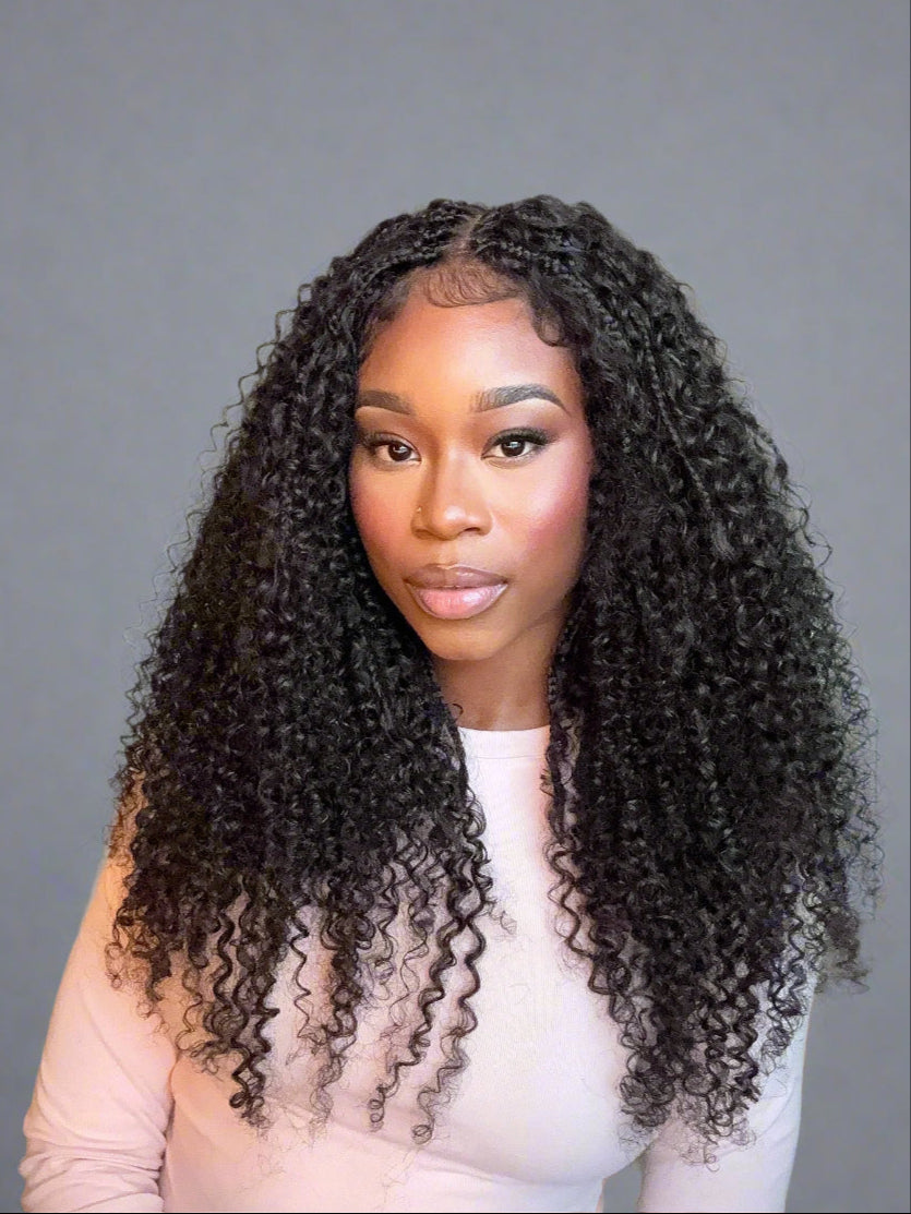 Woman with long, curly hair against a gray background