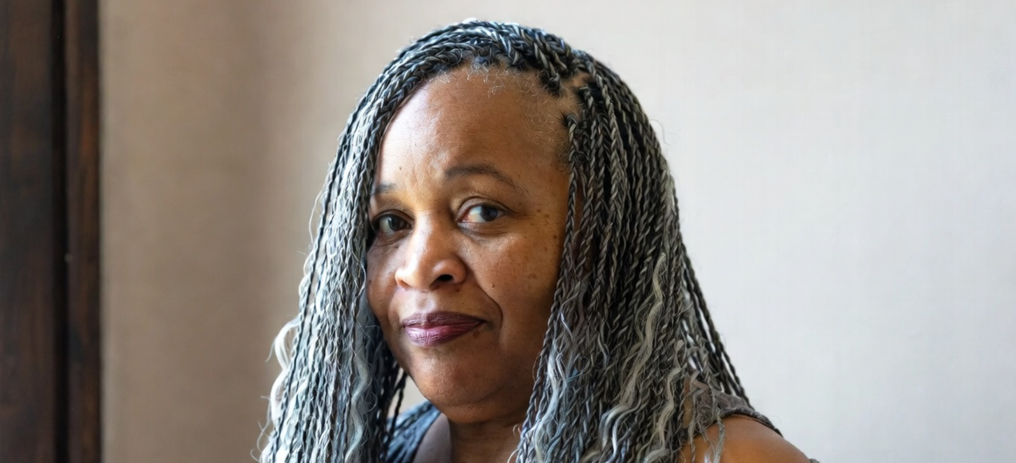 salt & pepper boho braids on 50 year old black woman